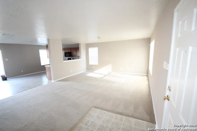 a view of a big room with wooden floor and cabinet