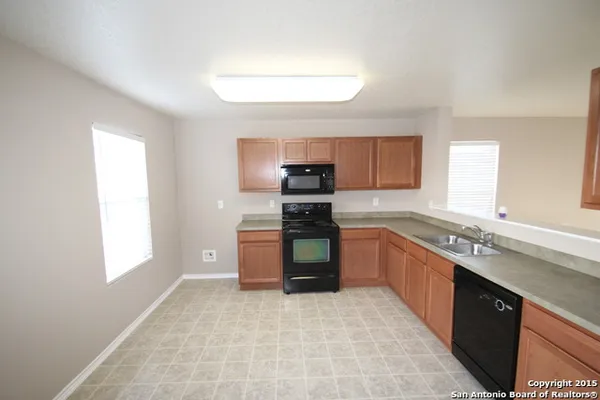 a kitchen with stainless steel appliances granite countertop a stove sink and cabinets