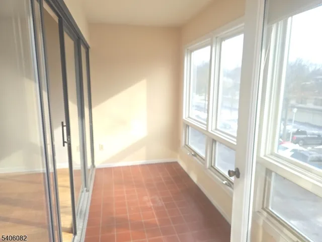 a view of an empty room and a window