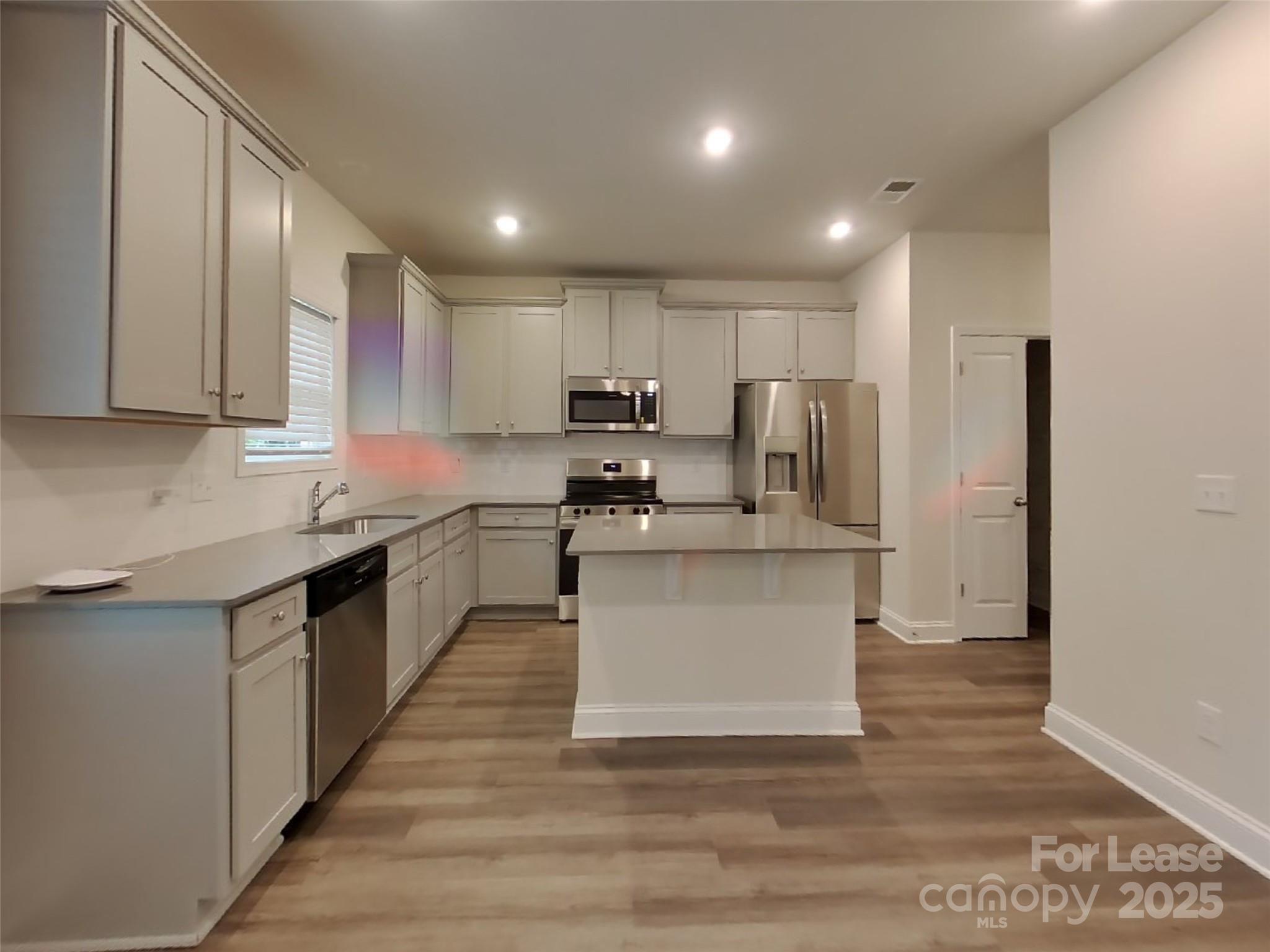139 Queenshall Road Mooresville, NC 28117 - Photo 11 of 24 a kitchen with a refrigerator and a stove top oven