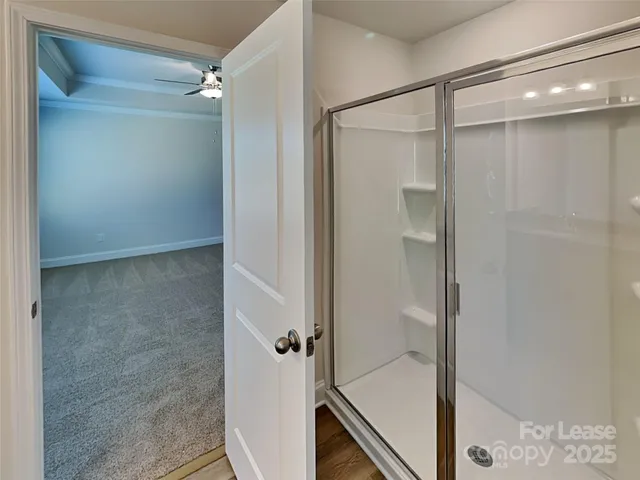 a bathroom with a glass shower door