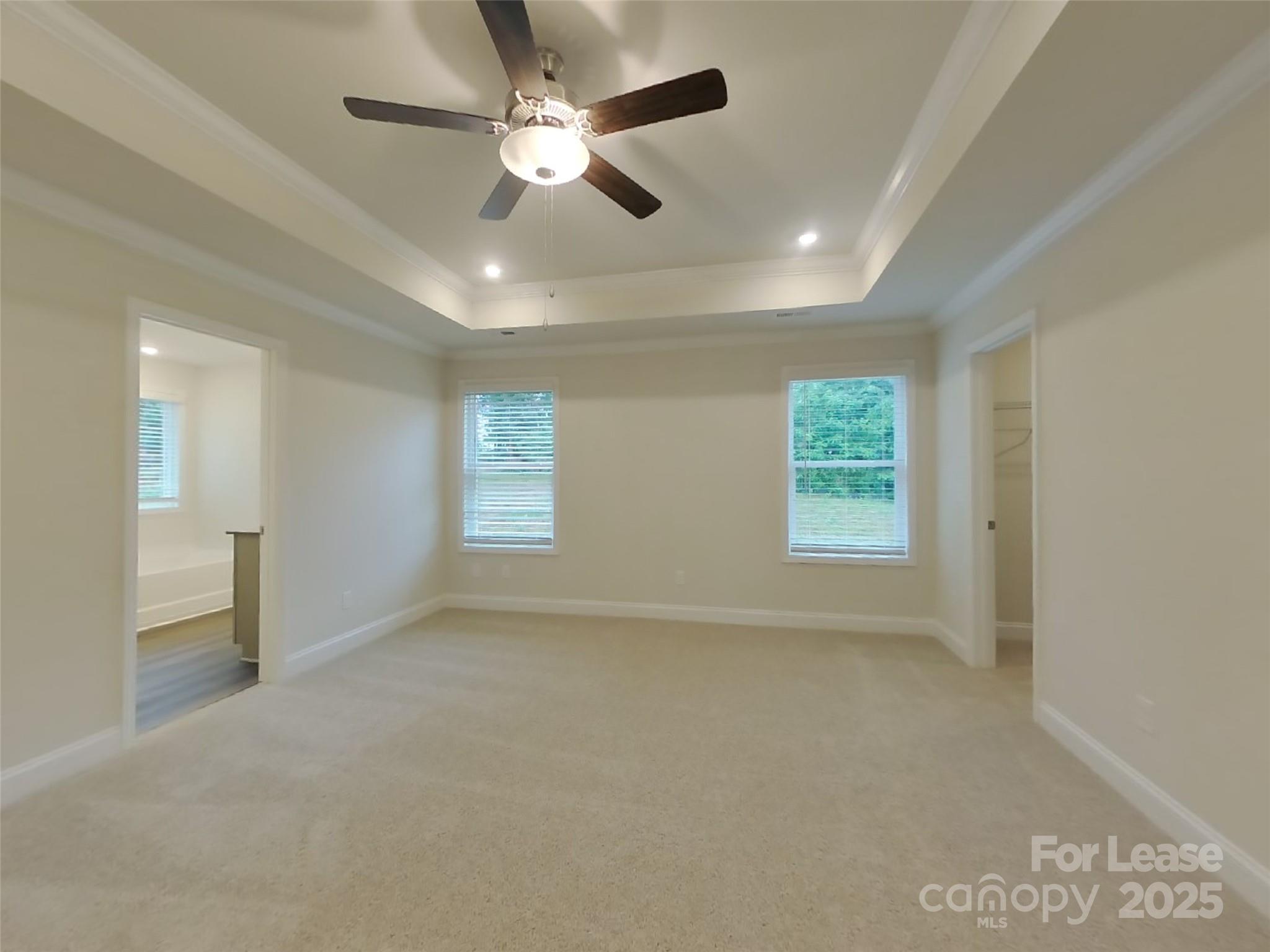 139 Queenshall Road Mooresville, NC 28117 - Photo 20 of 24 en empty room with windows and ceiling fan