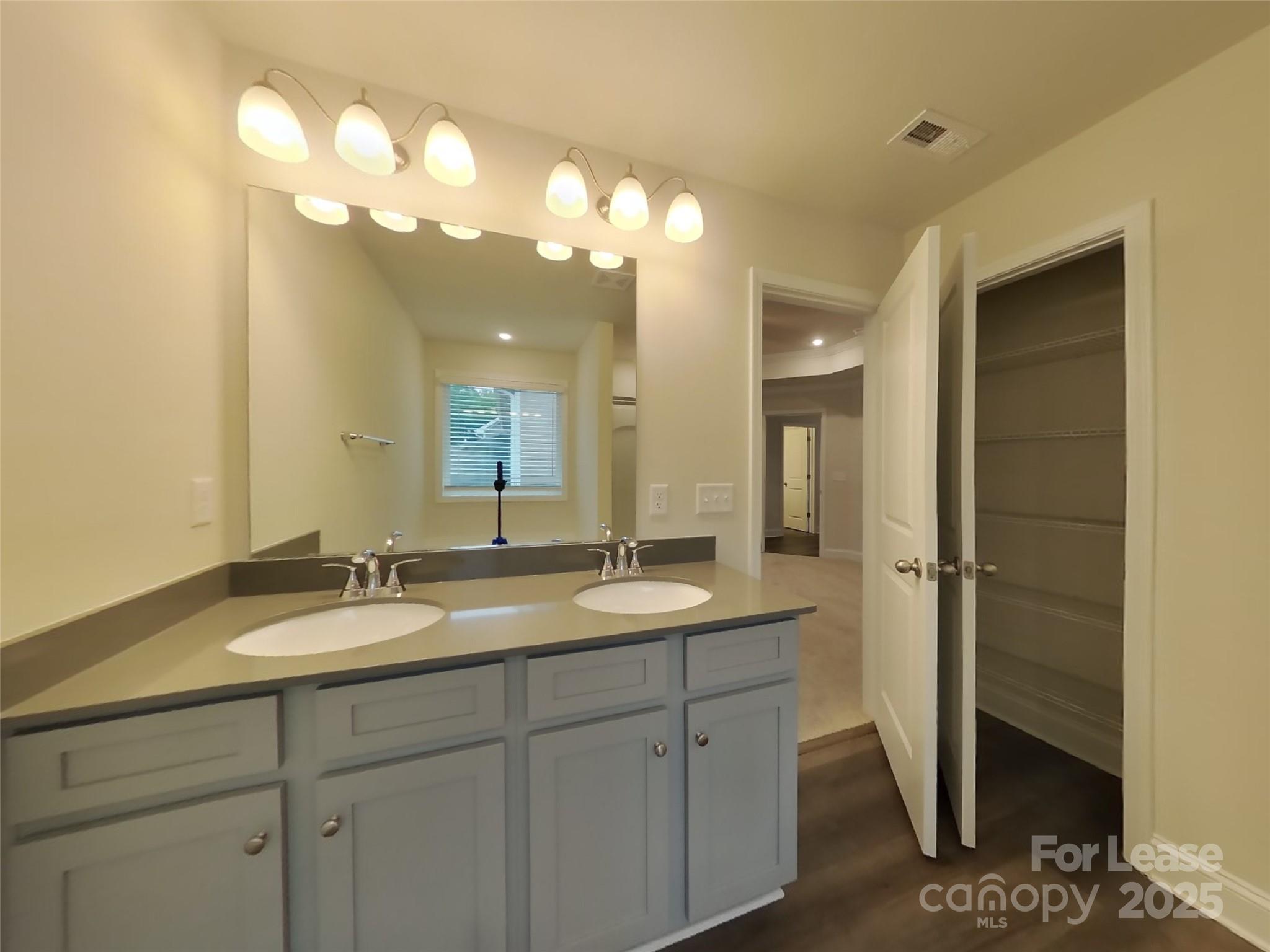 139 Queenshall Road Mooresville, NC 28117 - Photo 24 of 24 a bathroom with a granite countertop sink a large mirror and a shower