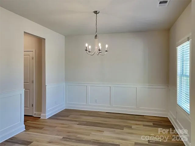 a view of a room with wooden floor and windows