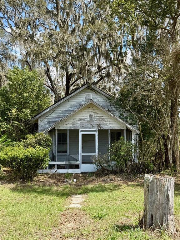 a front view of a house with a yard and porch