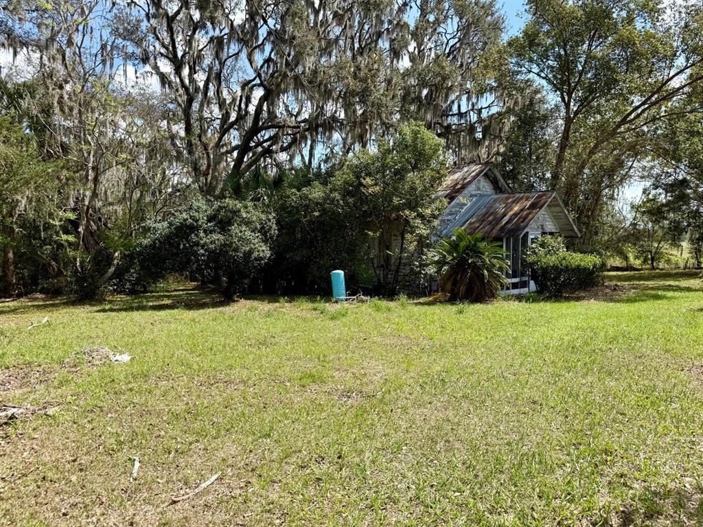 10010 Fort King Road Dade City, FL 33525 - Photo 34 of 36 a view of outdoor space with deck and trees