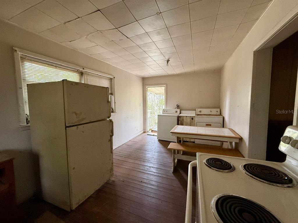 10010 Fort King Road Dade City, FL 33525 - Photo 6 of 36 a view of workspace with furniture and wooden floor