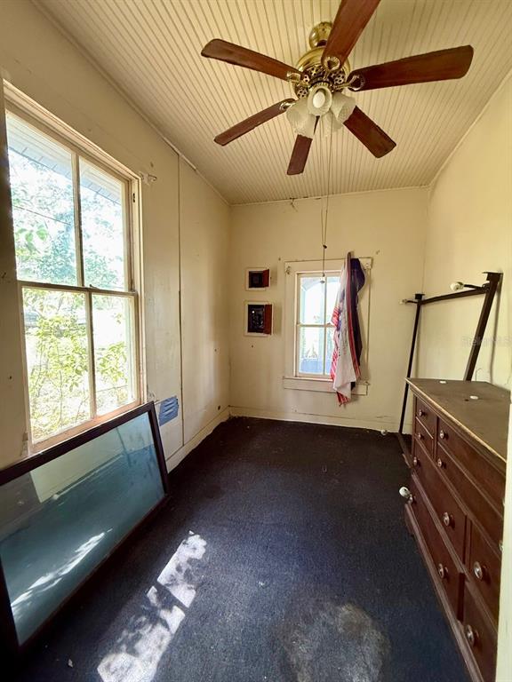 10010 Fort King Road Dade City, FL 33525 - Photo 10 of 36 a view of an empty room with window and chandelier fan
