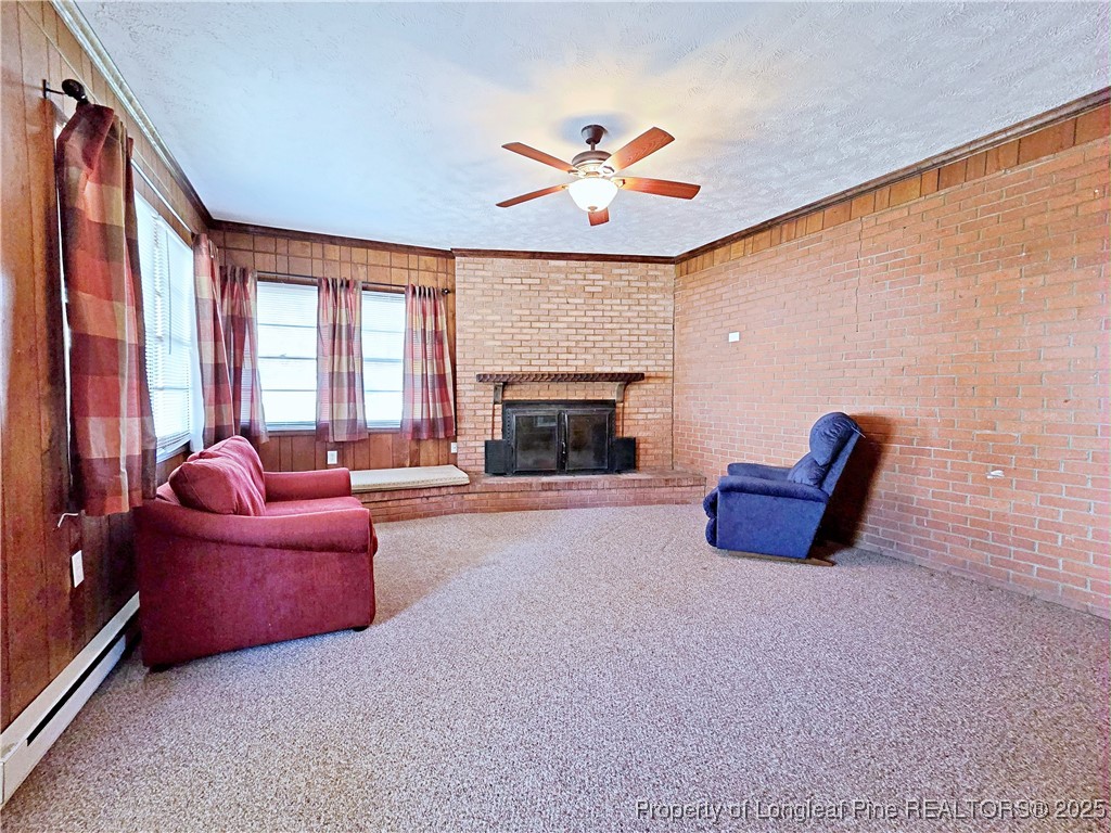 764 Old Vander Road Fayetteville, NC 28312 - Photo 14 of 50 a living room with furniture a fireplace and a large window