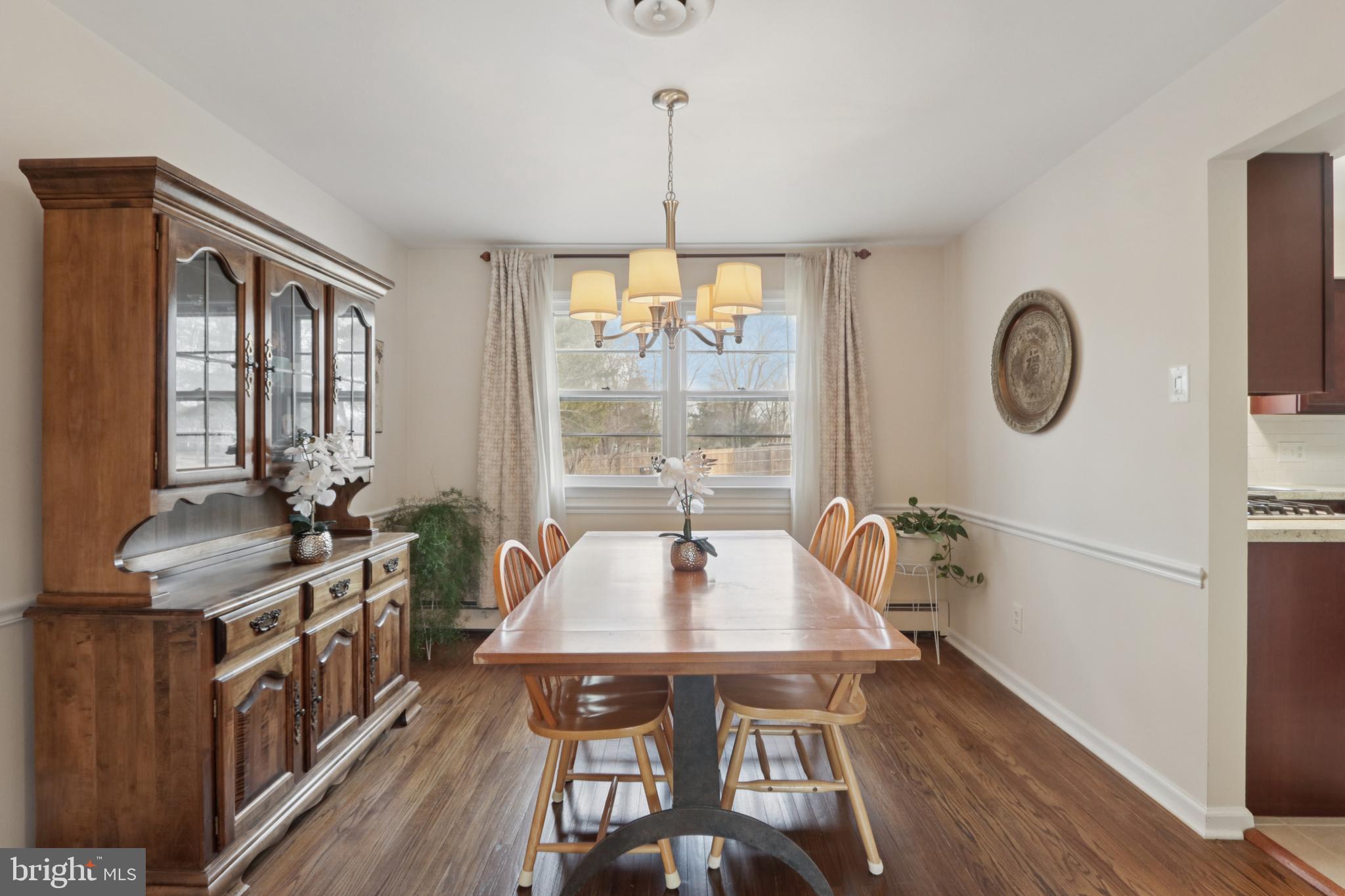 980 Bear Tavern Road Titusville, NJ 08560 - Photo 14 of 66 a dining room with wooden floor a chandelier a wooden table and chairs