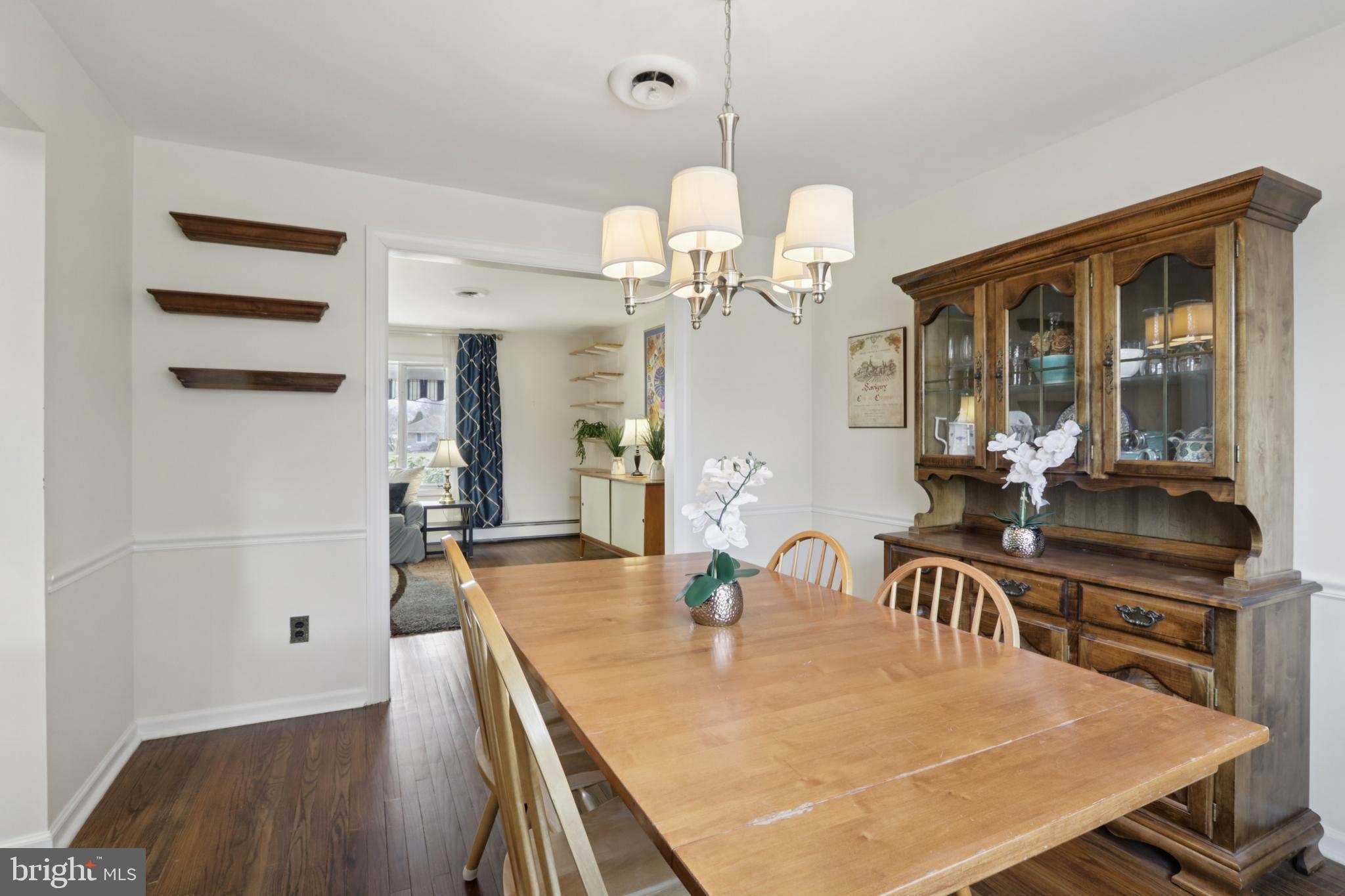 980 Bear Tavern Road Titusville, NJ 08560 - Photo 17 of 66 a dining room with wooden floor a chandelier a wooden table and chairs