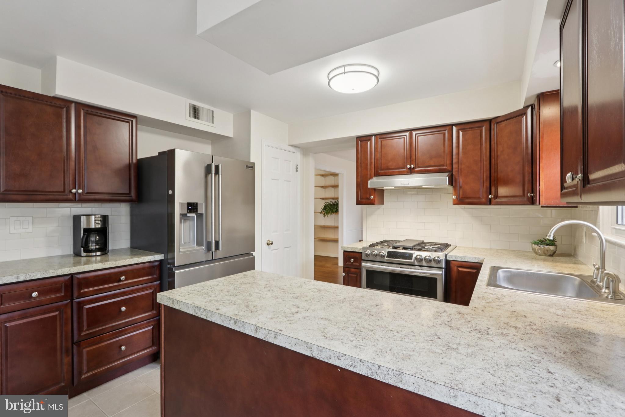 980 Bear Tavern Road Titusville, NJ 08560 - Photo 23 of 66 a kitchen with kitchen island granite countertop a stove top oven a sink dishwasher a refrigerator and cabinets with wooden floor