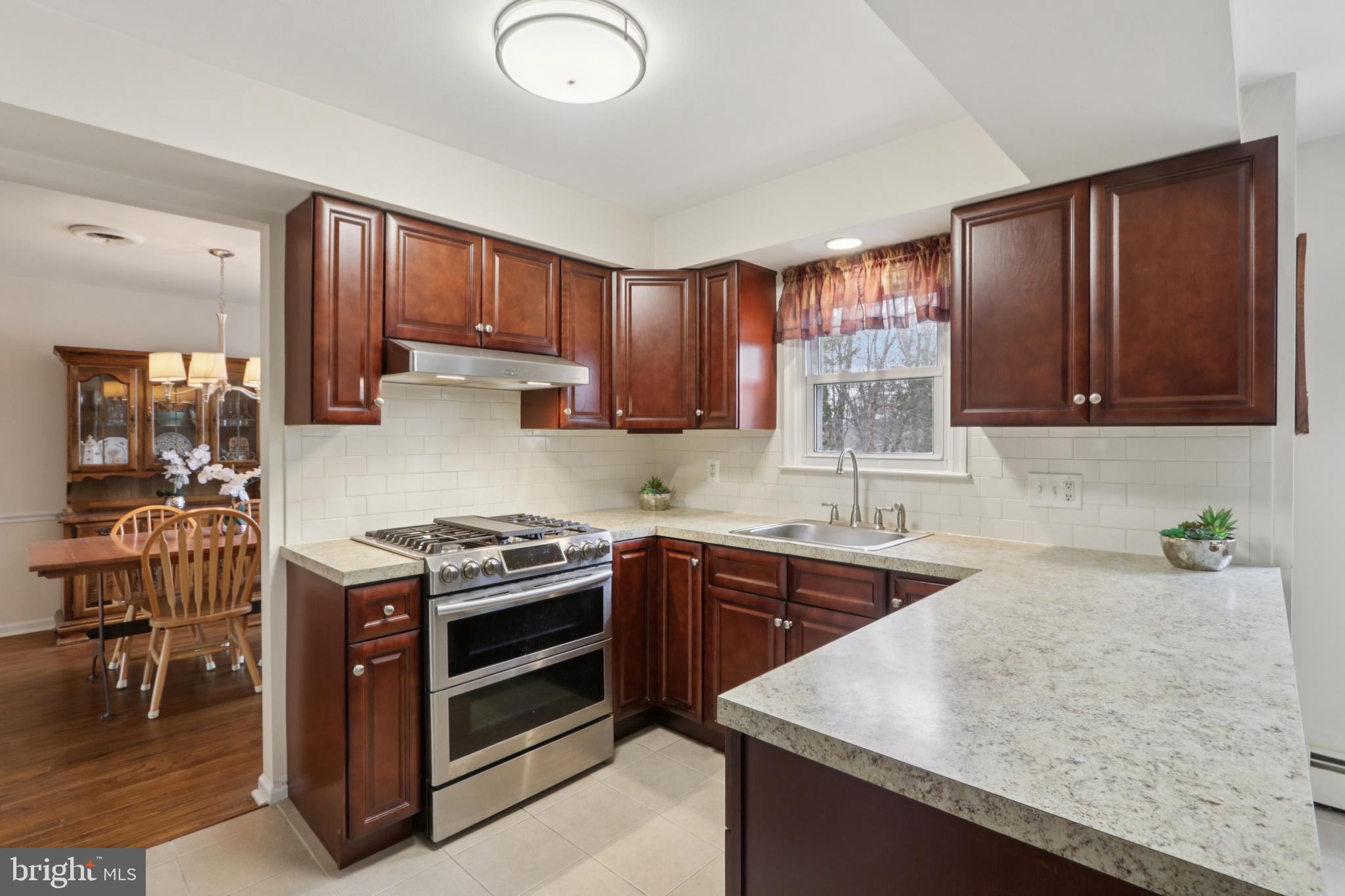 980 Bear Tavern Road Titusville, NJ 08560 - Photo 24 of 66 a kitchen with stainless steel appliances granite countertop wooden cabinets a stove top oven a sink and dishwasher