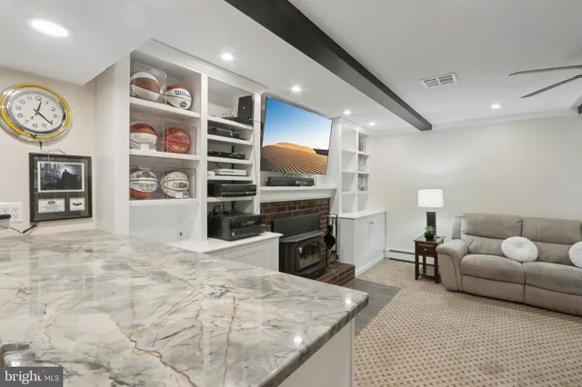 a bathroom with a granite countertop sink a mirror and shower