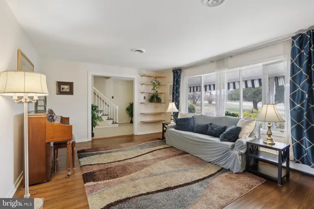 a spacious bedroom with a bed couch and a window