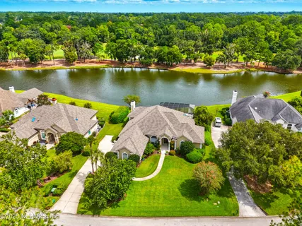 an aerial view of a house with a swimming pool outdoor seating and yard