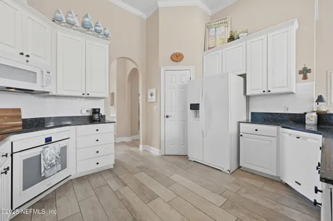 a kitchen with stainless steel appliances a refrigerator sink and cabinets