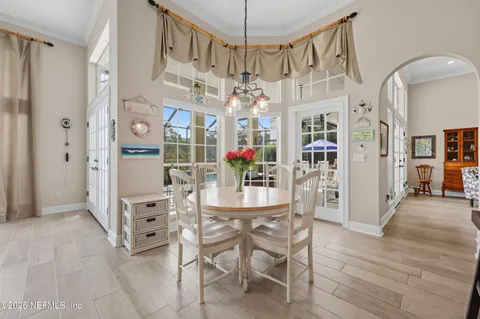 a view of a dining room with furniture and a chandelier
