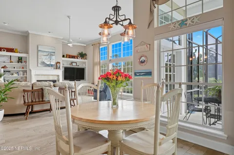 a view of a dining room with furniture and a potted plant