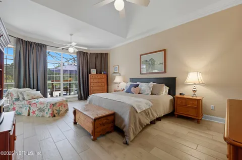 a spacious bedroom with a bed and a large window