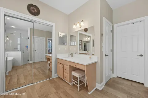 a bathroom with a shower sink and mirror