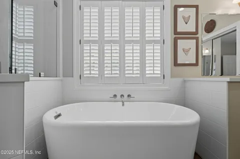 a white bath tub sitting next to a window