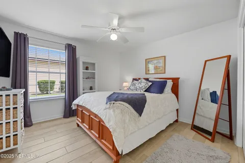 a bedroom with a bed and a window