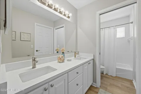 a bathroom with a sink double vanity and a mirror