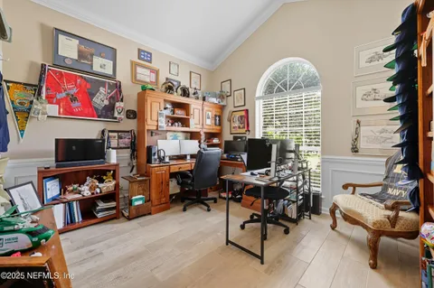 a view of a livingroom with workspace and a window