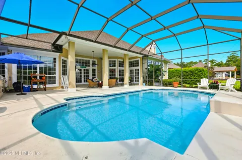 a view of a patio with a table and chairs under an umbrella