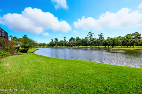 a view of a lake with houses in the back