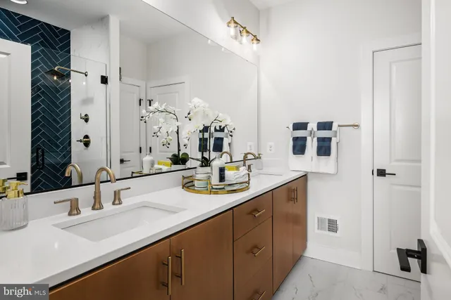 a bathroom with a sink double vanity granite and a mirror