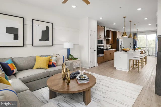 a living room with furniture kitchen and a table