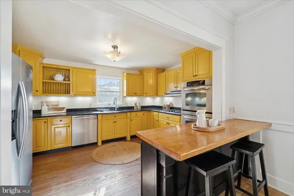 a kitchen with wooden cabinets and a stove top oven