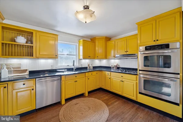 a kitchen with sink cabinets and window
