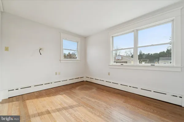 a view of an empty room and wooden floor
