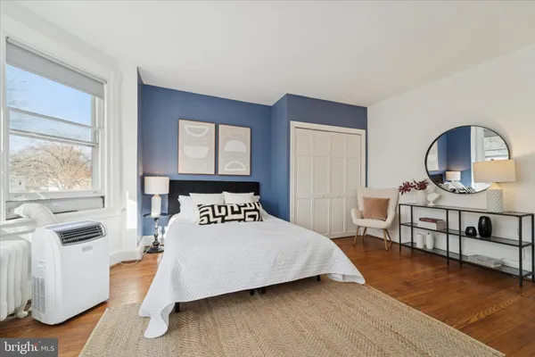 a bedroom with a bed and a window