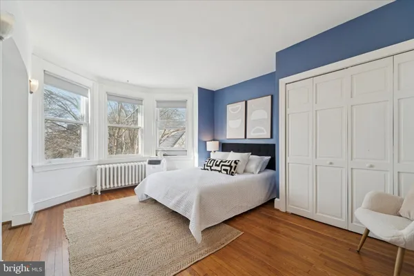 a bedroom with bed and a window