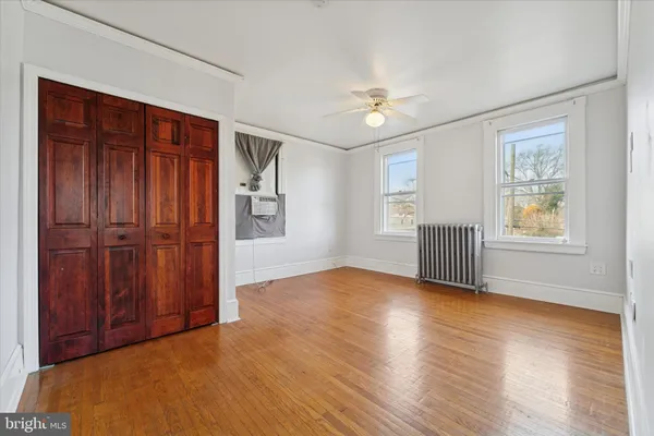 a view of a room with wooden floor