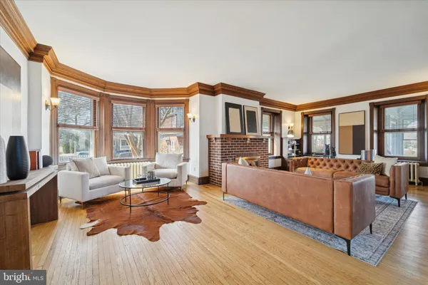 a living room with furniture fireplace and wooden floor