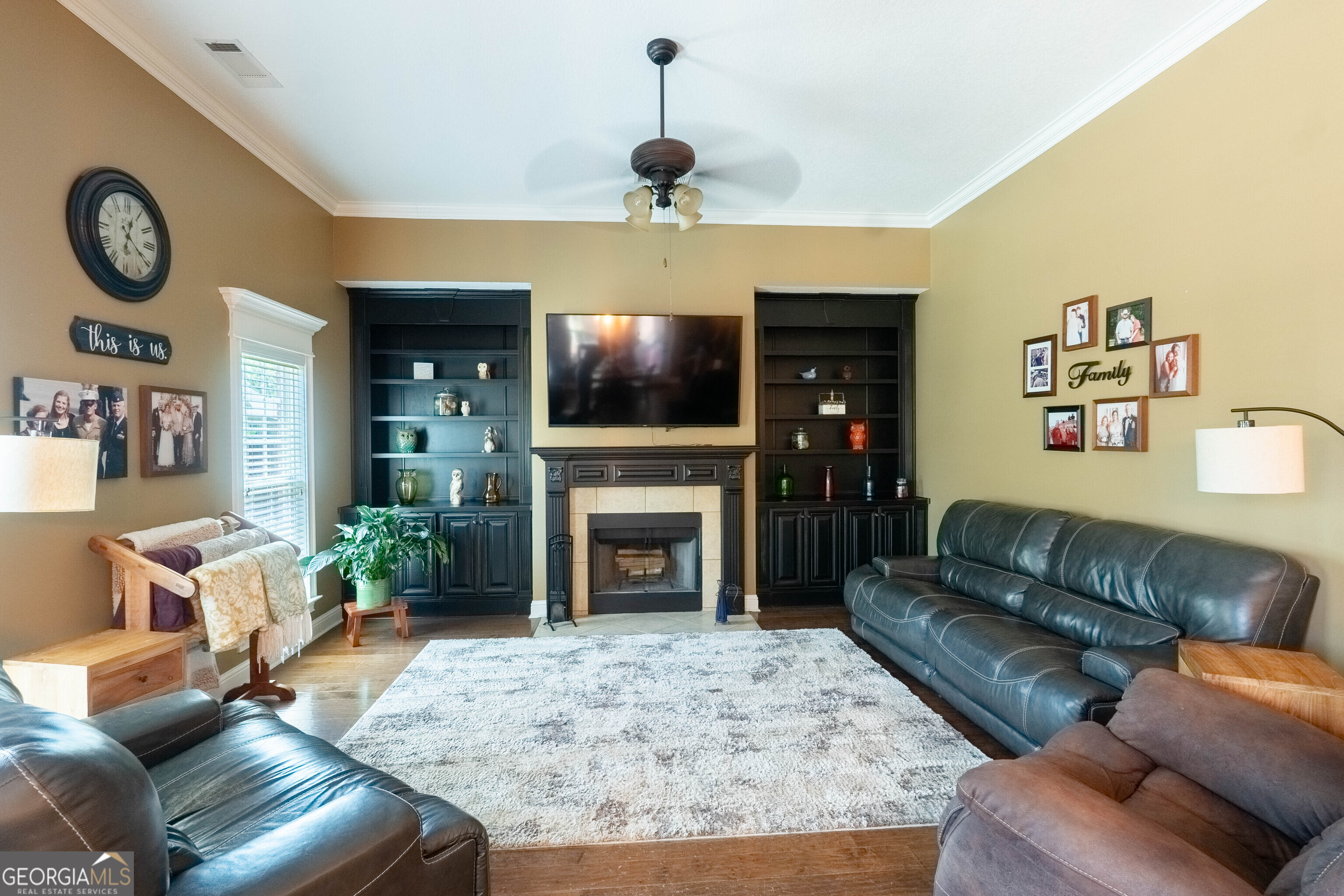 501 Old Bridge Road Warner Robins, GA 31088 - Photo 16 of 54 a living room with furniture a fireplace and a flat screen tv