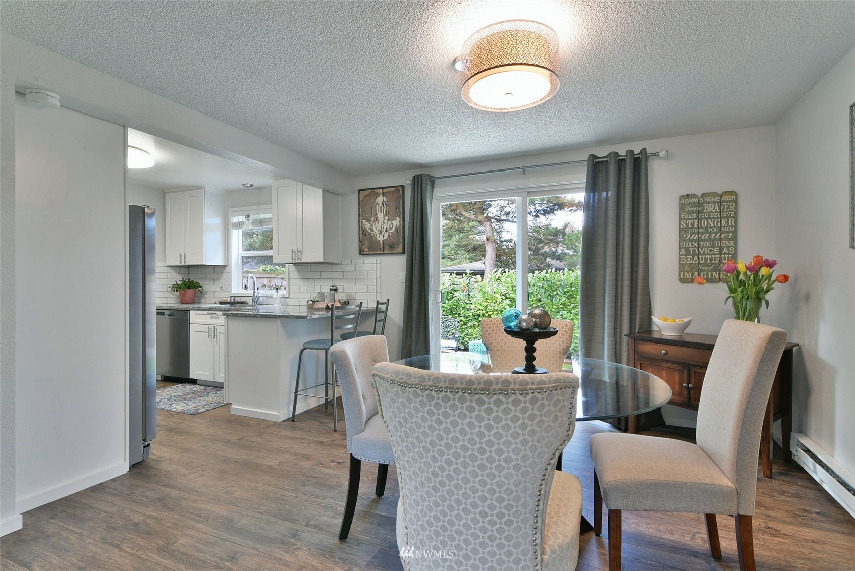 6320 Cady Road, Unit A Everett, WA 98203 - Photo 8 of 19 a view of a dining room with furniture window and wooden floor