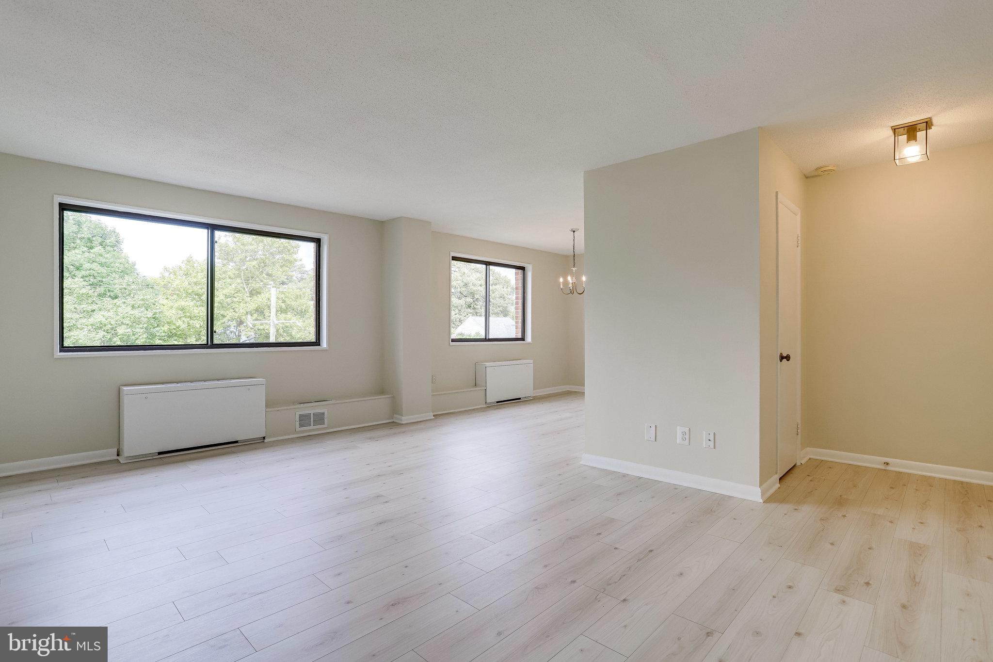 3515 Washington Boulevard, Unit 415 Arlington, VA 22201 - Photo 17 of 60 a view of an empty room with a window and wooden floor