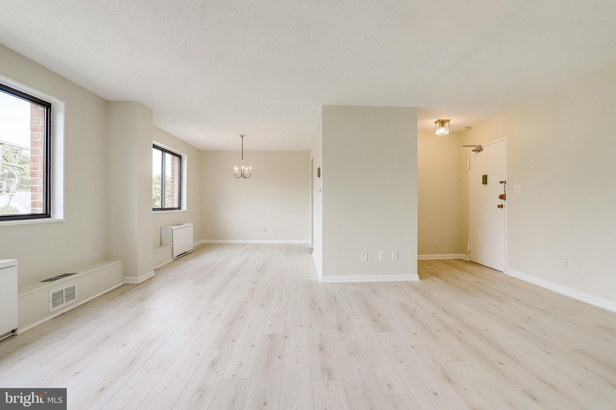3515 Washington Boulevard, Unit 415 Arlington, VA 22201 - Photo 18 of 60 a view of an empty room with wooden floor and a window