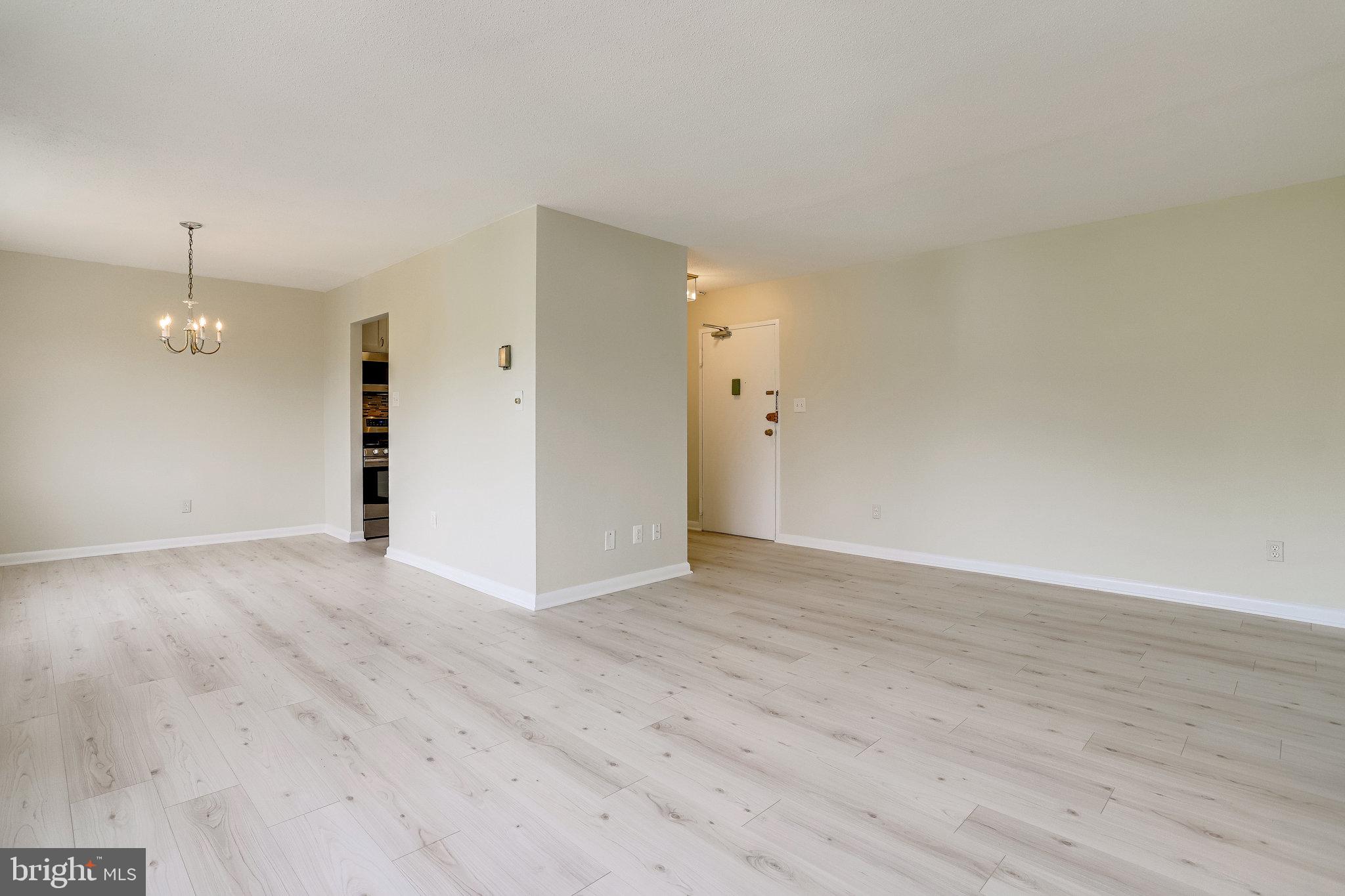 3515 Washington Boulevard, Unit 415 Arlington, VA 22201 - Photo 19 of 60 a view of an empty room with wooden floor