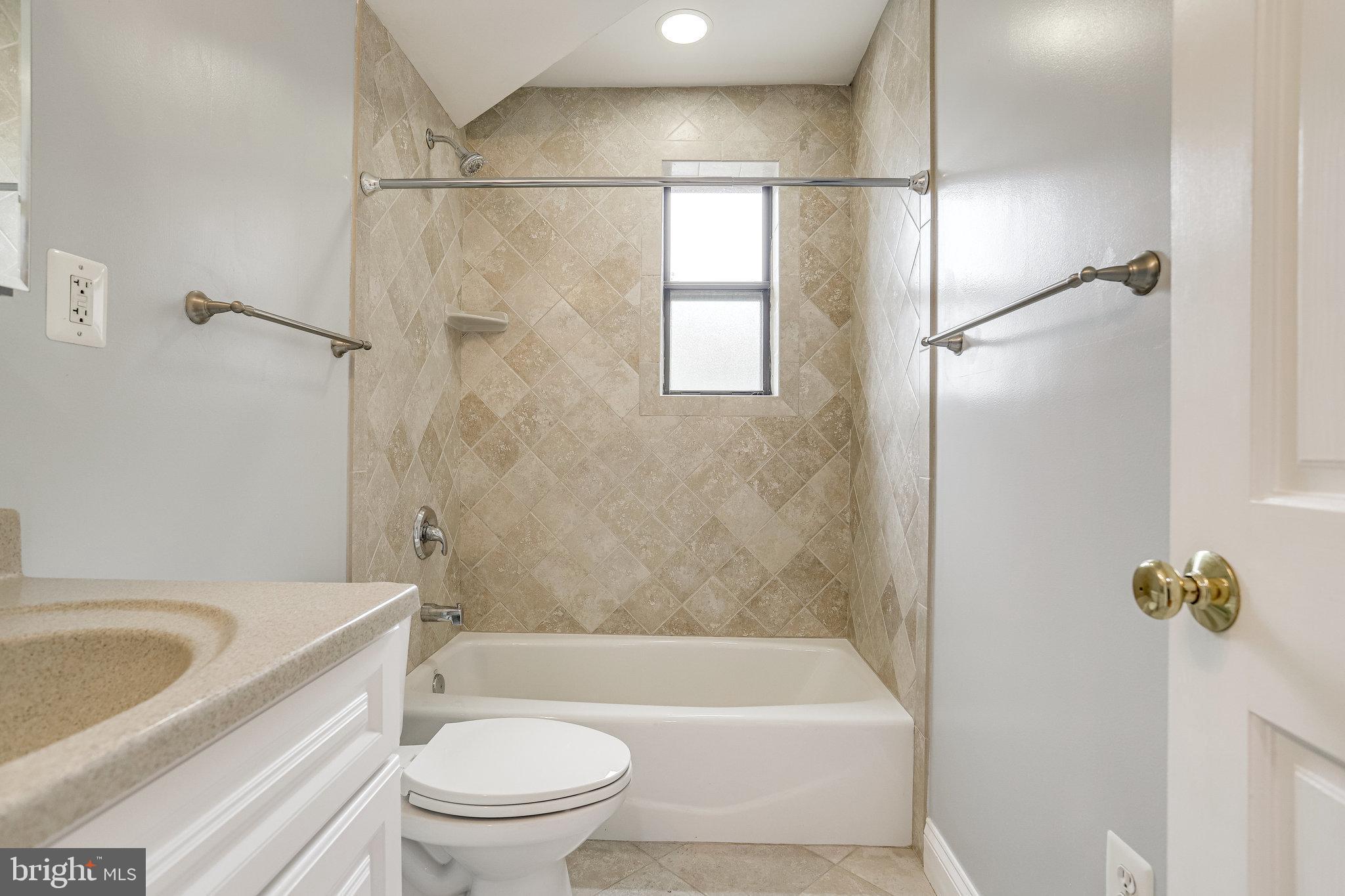 3515 Washington Boulevard, Unit 415 Arlington, VA 22201 - Photo 2 of 60 a bathroom with a granite countertop bathtub shower sink vanity and toilet