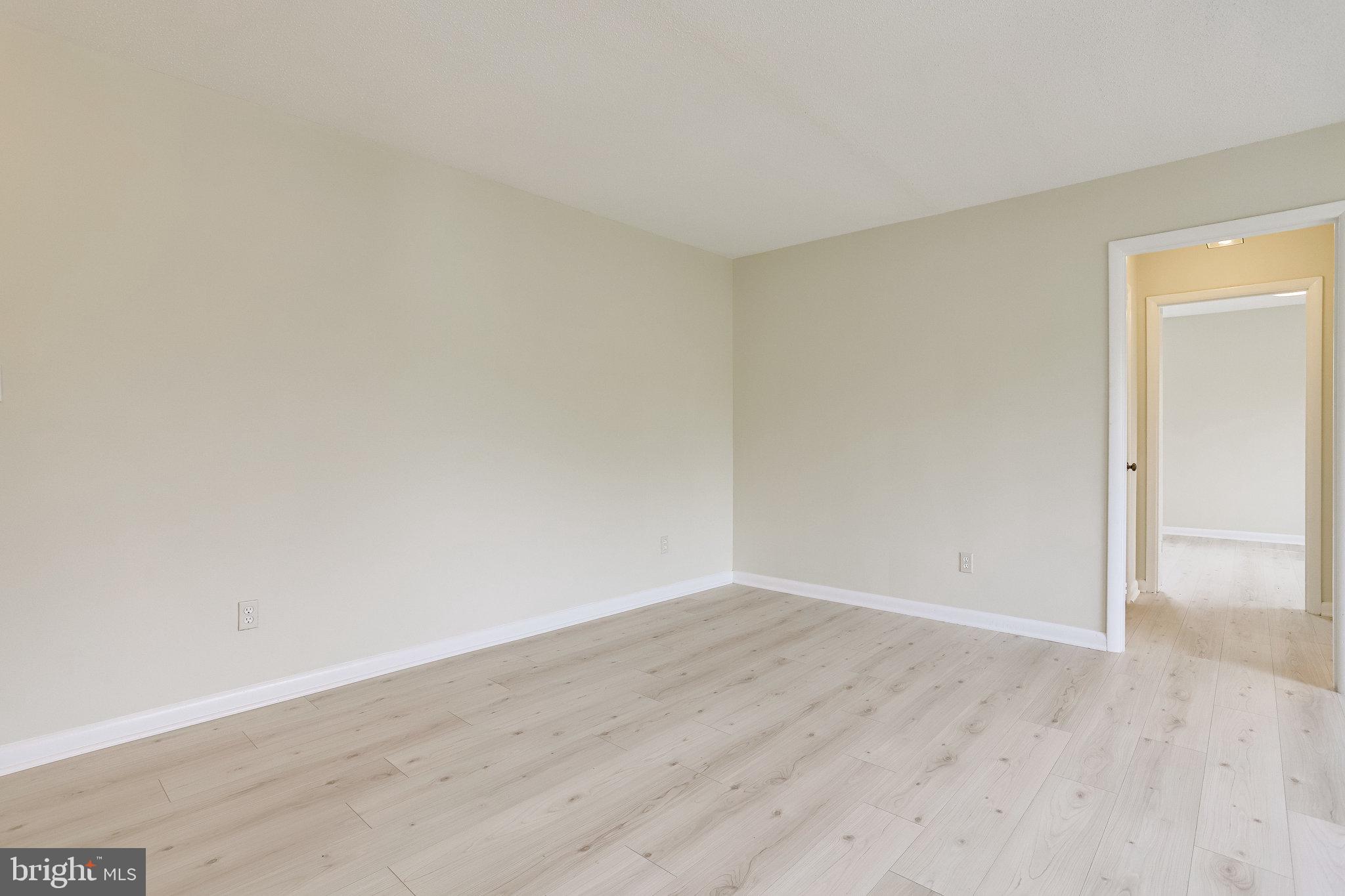 3515 Washington Boulevard, Unit 415 Arlington, VA 22201 - Photo 23 of 60 a view of an empty room with wooden floor