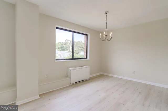 a view of a room with wooden floor and cabinets