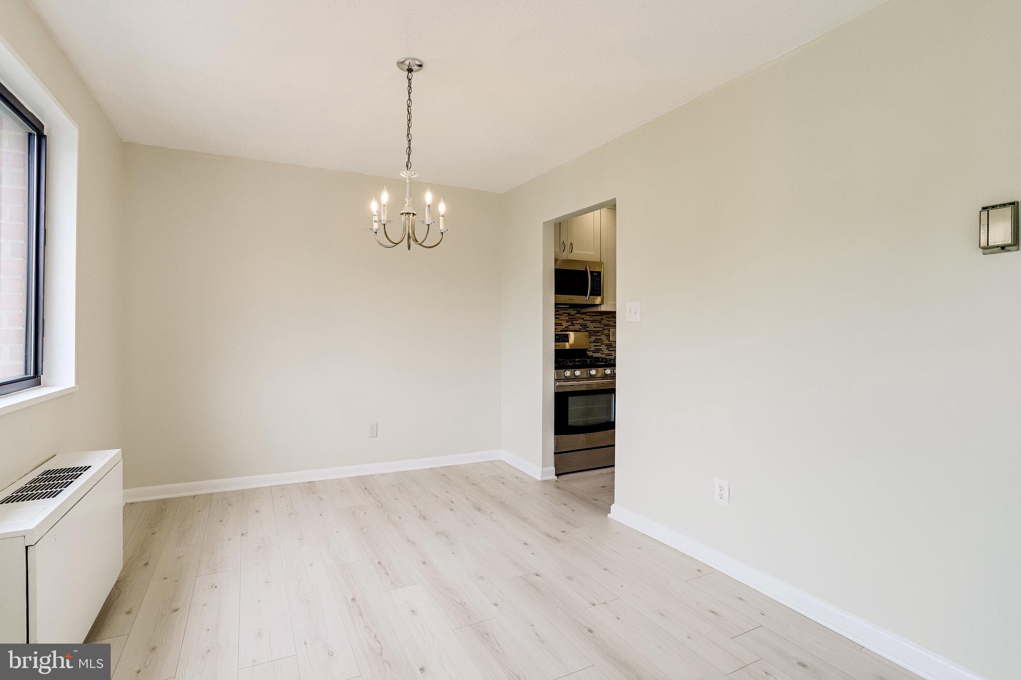 3515 Washington Boulevard, Unit 415 Arlington, VA 22201 - Photo 26 of 60 a view of a room with wooden floor and cabinets