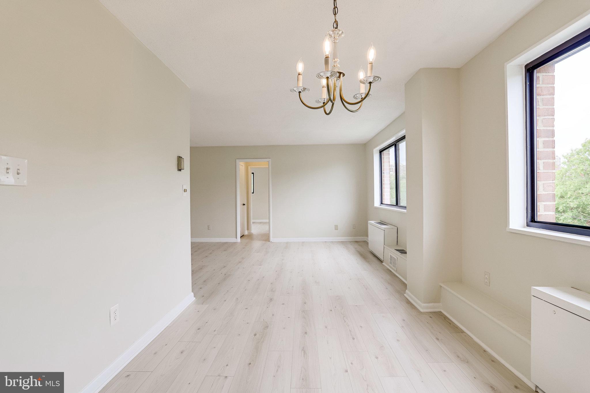 3515 Washington Boulevard, Unit 415 Arlington, VA 22201 - Photo 27 of 60 a view of empty room with wooden floor and window